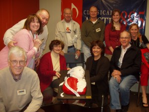 KMFA staff and volunteers pose with a Mozart birthday cake during the 2008 Birthday Drive