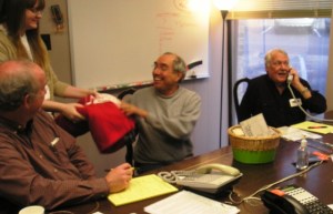 (Sarah hands over another "Snuffluffagus" blankie to a happy pledger)